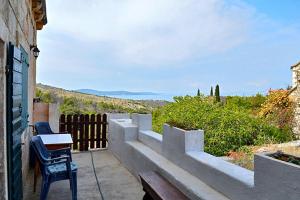 a balcony with a bench and a view of the hills at Holiday house with a parking space Bobovisca, Brac - 11435 in Ložišće