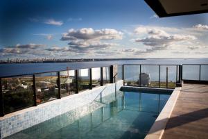 a swimming pool with a view of the water at Apartamento en Sognare in Encarnación