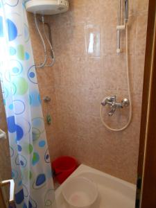 a small bathroom with a shower and a toilet at Apartments by the sea Cove Ostricka luka, Rogoznica - 11451 in Zaglavice