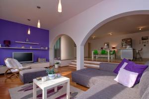 a living room with purple walls and a couch and a table at Apartment Hvar 11427a in Hvar