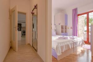 a bedroom with a bed and a mirror in a room at Apartment Hvar 11427a in Hvar
