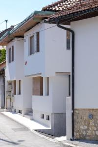 a house with white walls and a street at Mayisa Apartments in Sarajevo