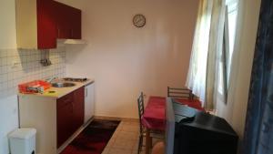 a small kitchen with a sink and a table with a table at Studio Barbat 11472a in Rab