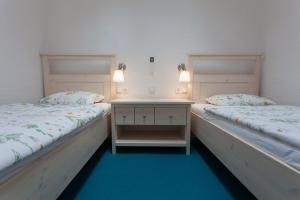 two beds sitting next to each other in a room at Holiday house with a parking space Kornic, Krk - 11504 in Kornić