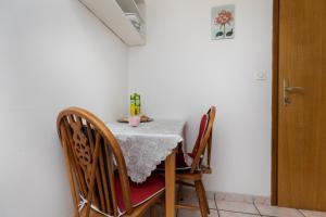 a table with chairs and a white table cloth on it at Apartment Sumpetar 11462a in Jesenice +23 photos