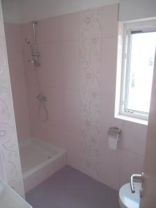 a white bathroom with a shower and a sink at Apartments by the sea Savar, Dugi otok - 11540 in Brbinj