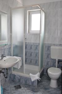 a bathroom with a shower and a sink and a toilet at Apartments with a parking space Selce, Crikvenica - 11527 in Selce