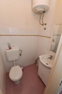 a small bathroom with a toilet and a sink at Apartments by the sea Rtina - Miletici, Zadar - 11548 in Ražanac