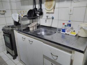 a kitchen counter with a sink and a stove at Hostel Hay's 1 Aeroporto Boa Viagem in Recife +31 photos