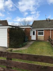 a house with a fence in front of it at The Bungalow, Lingdale in Lingdale