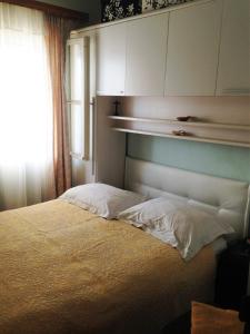 a bedroom with a bed with white sheets and a window at Seaside holiday house Prigradica, Korcula - 11484 in Blato