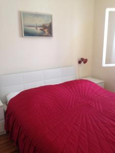 a red bed in a white room with a red blanket at Seaside holiday house Prigradica, Korcula - 11484 in Blato