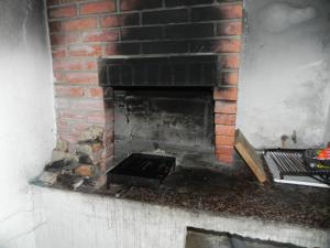 a brick fireplace with a grate in it at Apartment Sveta Nedilja 11433a in Jelsa