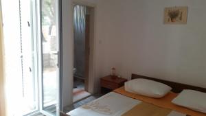 a small bedroom with a bed and a window at Apartments by the sea Sveta Nedilja, Hvar - 11433 in Sveta Nedelja