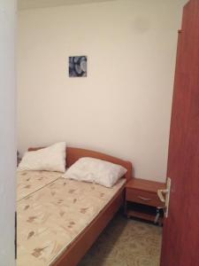 a small bedroom with a bed and a night stand at Apartment Sveta Nedilja 11433c in Sveta Nedelja