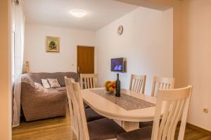 a dining room and living room with a table and chairs at Apartments with a parking space Trpanj, Peljesac - 11545 in Trpanj