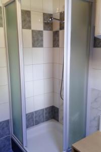 a shower with a glass door in a bathroom at Holiday house with a parking space Smoljanac, Plitvice - 13741 in Smoljanac +10 photos