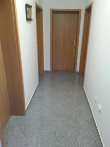 an empty hallway with a door and a room at Apartments by the sea Vinisce, Trogir - 13775 in Vinišće