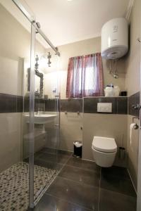 a bathroom with a toilet and a sink and a shower at Apartments by the sea Vinjerac, Zadar - 13811 in Posedarje