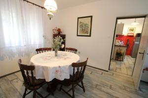a dining room with a table with a vase on it at Apartments by the sea Vinjerac, Zadar - 13811 in Posedarje
