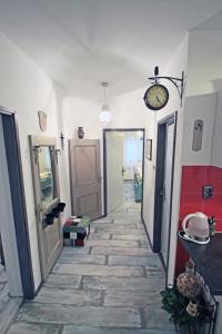a room with a hallway with a clock on the wall at Apartments by the sea Vinjerac, Zadar - 13811 in Posedarje