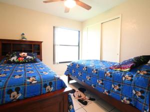 a bedroom with two beds with stuffed animals on it at 2 Bed 5325 in Kissimmee