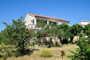 a house with trees in front of it at Apartments with swimming pool Poljica, Zadar - 13838 in Vrsi
