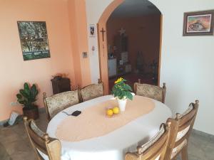 a table with oranges and a potted plant on it at Apartments with a parking space Omis - 13785 in Omiš