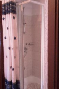 a bathroom with a shower with a shower curtain at Apartments by the sea Prvic Luka, Prvic - 13845 in Prvić Luka