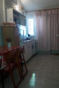 a kitchen with a table and a table and a window at Apartments by the sea Prvic Luka, Prvic - 13845 in Prvić Luka