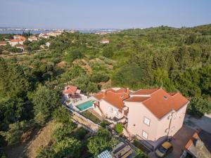 an aerial view of a house with a swimming pool at Family friendly apartments with a swimming pool Sutomiscica, Ugljan - 13872 in Preko