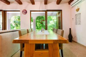 a dining room with a wooden table and chairs at Family friendly house with a parking space Tribalj, Crikvenica - 13877 in Tribalj