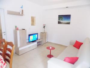 a living room with a couch and a tv at Apartments with a parking space Matulji, Opatija - 13890 in Matulji