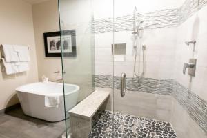 a bathroom with a shower and a tub and a sink at Bald Eagle Two Bedroom apartment hotel in Park City