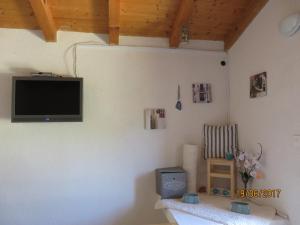 a living room with a television on the wall at Secluded house with a parking space Beli, Cres - 13893 in Beli