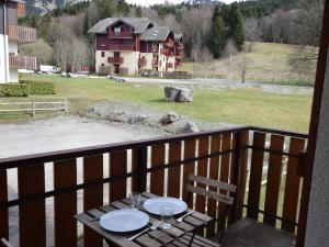 a table on a balcony with a view of a house at Studio Bernex, 1 pièce, 4 personnes - FR-1-498-36 in Bernex