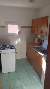 a small kitchen with a stove and a window at Apartments with a parking space Rudina, Hvar - 13903 in Stari Grad