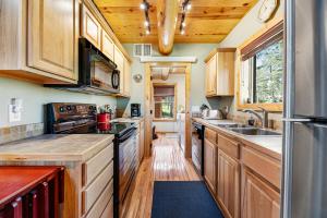 a kitchen with wooden cabinets and a sink at Boulder Ridge Lodge in Lead