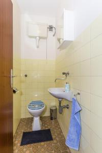 a bathroom with a toilet and a sink at Apartments with WiFi Split - 13957 in Split