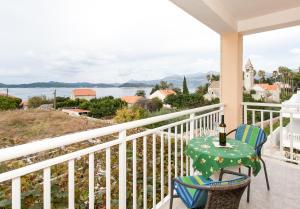 a balcony with a table and chairs and a view of the water at Apartments and rooms by the sea Lopud, Elafiti - 14013 in Lopud Island