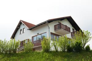 a house with balconies on the side of it at Double Room Smoljanac 14023b in Smoljanac