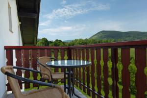 a table and chairs on a balcony with a view at Double Room Smoljanac 14023b in Smoljanac