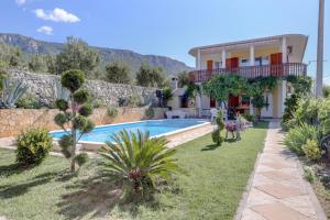 a villa with a swimming pool and a house at Family friendly apartments with a swimming pool Kastel Sucurac, Kastela - 14047 in Kaštela