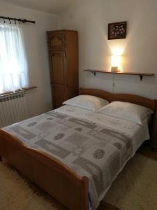 a bedroom with a bed and a lamp and a window at Family friendly house with a swimming pool Popovici, Zagora - 14074 in Benkovac