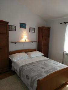 a bedroom with a large bed and two dressers at Family friendly house with a swimming pool Popovici, Zagora - 14074 in Benkovac