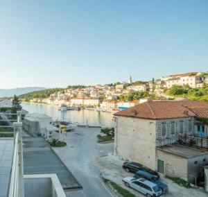 a view of a city with a river and buildings at Apartments by the sea Povlja, Brac - 14126 in Povlja +7 photos