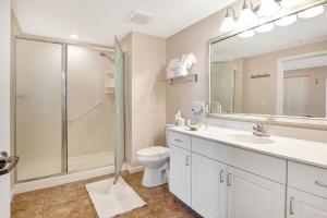 a bathroom with a shower and a toilet and a sink at Vitamin Sea - Modern Beach Highrise At Ocean Walk Resort Daytona Beach in Daytona Beach