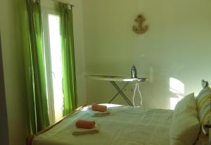 a bedroom with a bed with green curtains and a window at Apartment Zubovici 13966b in Zubovići