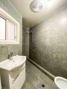 a bathroom with a sink and a shower at large Group house in Windy Corner