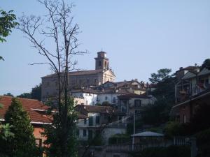 a building on top of a hill with houses at Casa Lanze in Castagnole Lanze